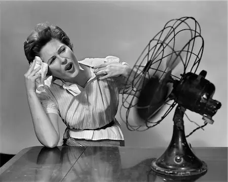 woman with a fan showing you how to cool your home